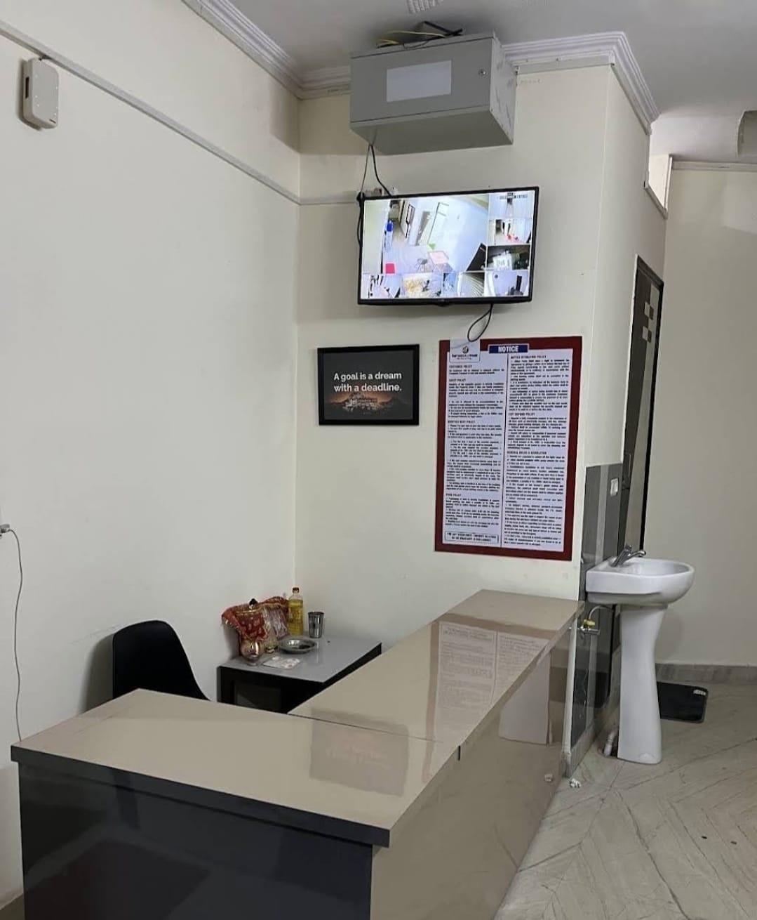 Reception desk with CCTV monitor at Vrinda Girls PG