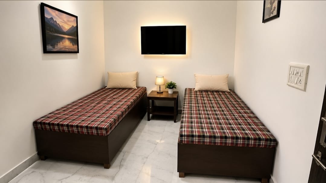 Cozy twin room with wall TV and warm lighting