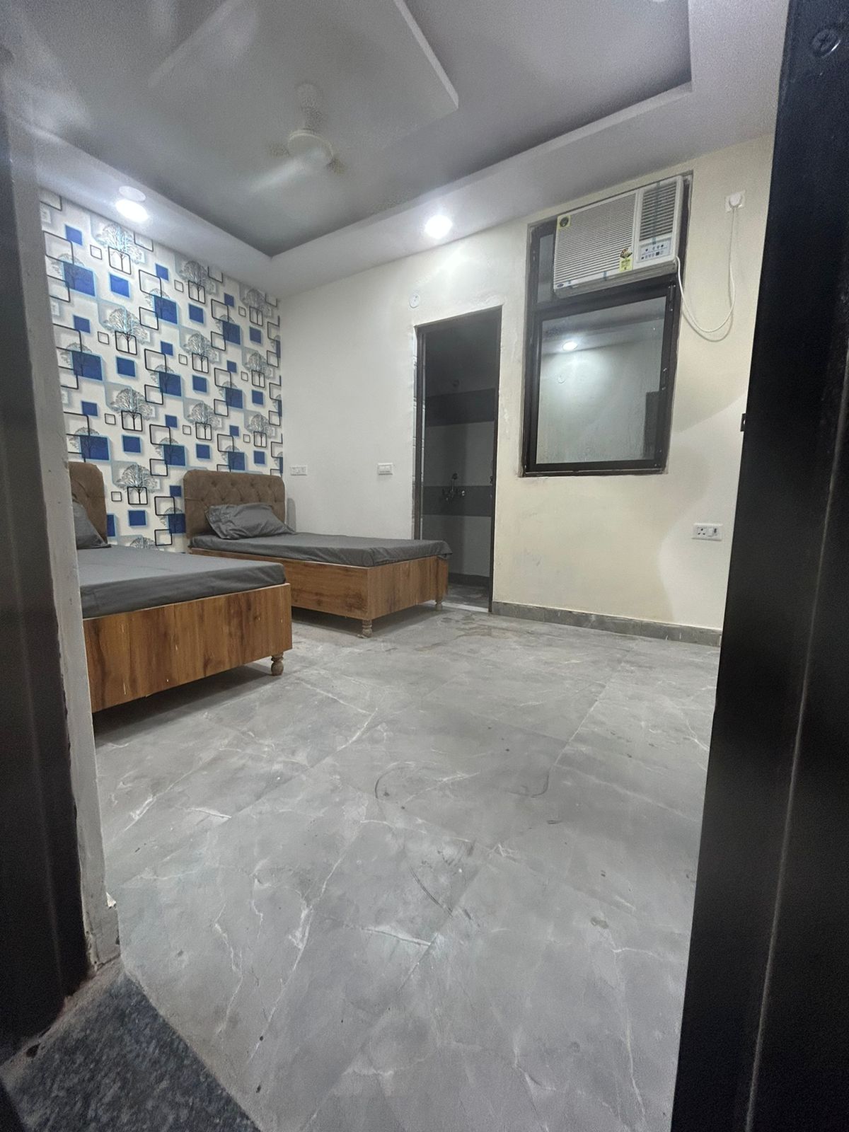 Twin sharing room with AC and accent wall